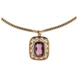 Purple paste set 9ct gold pendant, 6.9g gross; on a filed curb link 18ct gold chain, 61cm long,