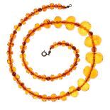 Graduated row of facetted amber beads, the ninety-three alternating round beads, 6mm diameter and