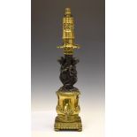 French brass and bronzed spelter figural table lamp, the cylindrical burner collar with plaque