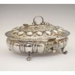 Victorian oval silver casket, the hinged cover with a serpent form handle, embossed ovals and