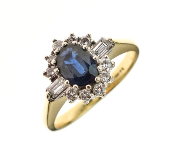 Diamond and sapphire 18ct gold ring, the oval cut sapphire enclosed by five brilliant cuts above