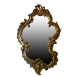 Rococo style giltwood and gesso wall mirror, 19th Century or earlier, of asymmetrical scroll outline