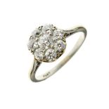 Eight stone diamond cluster ring, the white mount stamped 'Plat', the central brilliant cut of