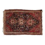 20th Century Middle Eastern wool rug, the dark blue field with three stepped lozenges and