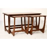 Nest of three 1960's/1970's period G-plan teak occasional tables comprising: a long coffee table and