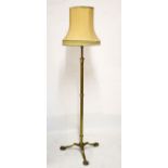 Early 20th Century brass adjustable standard lamp with tubular stem on tripod support Condition: