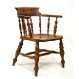 Late 19th/early 20th Century ash and beech smokers bow elbow chair having a typical spindle back,