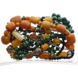 Five assorted bead necklaces to include; a malachite example plus three with large amber coloured