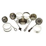 Various silver comprising: Edward VII tea strainer, Sheffield 1904, four various napkin rings and