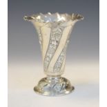 Victorian embossed silver trumpet shaped vase having stylised foliate decoration and standing on a