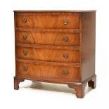 Reproduction mahogany bowfront chest of four long drawers with pierced back plate bale handles on