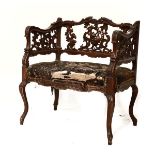 Early 20th Century Continental carved walnut and beech elbow chair having a stuffed seat and