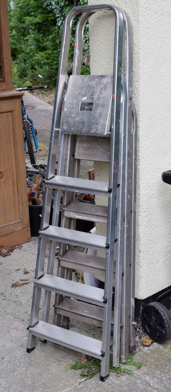 Two sets of aluminium folding steps of four and five treads respectively Condition: