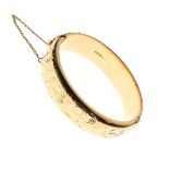 Engraved 9ct gold snap bangle, 24g approx Condition: