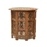 Indian octagonal top occasional table having allover heavily carved decoration, the folding base