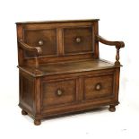 Early 20th Century oak box settle with two panel back and front Condition: