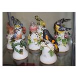 Eight Franklin Porcelain bells, each surmounted with a figure of a bird Condition: