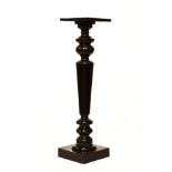 Early 20th Century ebonised torchère or vase stand with square top on turned tapering pedestal and