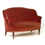 Late Victorian two seater drawing room settee upholstered in pink plush and standing on turned