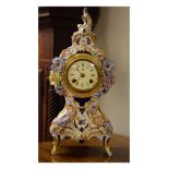 Reproduction porcelain cased mantel clock having floral encrusted decoration Condition: