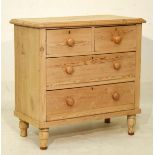 Stripped pine chest of two short over two long drawers on turned supports Condition: