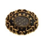 19th Century yellow metal oval mourning brooch having enamel decoration with script 'In Memory', and