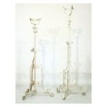 Two early 20th Century white painted wrought iron standard lamps, each to hold a paraffin cistern or