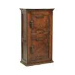 Late 17th Century oak cabinet with planked top over geometric two panel hinged door enclosing