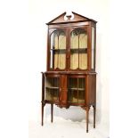 Edwardian string inlaid mahogany two section display cabinet, the upper section with a broken arch