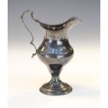 George III silver baluster shaped cream jug having a crimped edge, ogee scroll handle and standing