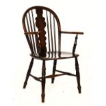 Early 20th Century beech Windsor elbow chair standing on turned supports united by stretchers