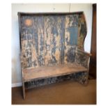 Good early 19th Century ash, elm and pine settle, the canopied planked back between shaped wings and
