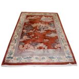 Chinese rug, the central field decorated with a lakeland landscape on a dark peach ground, the cream