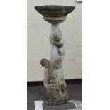 Reconstituted stone figural bird bath with three cherub supports Condition: