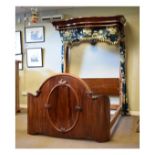 Victorian mahogany half tester double bed, the serpentine fronted canopy with hanging rail and