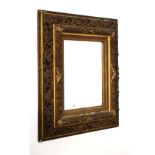 Antique gilt framed wall mirror, the plain rectangular plate within pierced foliate scroll