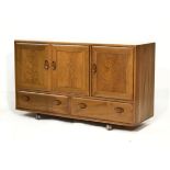 Ercol elm sideboard with three cupboards over two drawers Condition: