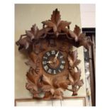 Late 19th/early 20th Century Black Forest carved walnut and beech cased cuckoo clock, having typical