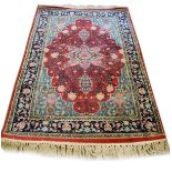 Good quality modern Middle Eastern rug decorated with a central medallion on a red ground within