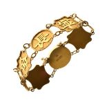 Chinese yellow metal bracelet set eight alternate circular and shaped panels with characters,