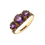 9ct gold ring set three purple stones, size O, 3.6g approx gross Condition: