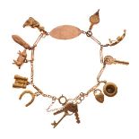Yellow bracelet set eleven various charms to include; keys, bellows, binoculars, shoe, pig and