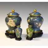 Pair of cloisonné baluster shaped vases and covers decorated with flowers, 19.5cm overall,