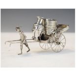 Chinese white metal or 'trade silver' 900 standard cruet set modelled as a China man pulling a