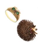 White metal hedgehog design brooch and a dress ring set green and white stones, the shank stamped