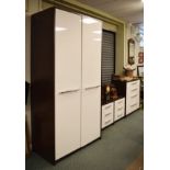 Modern four piece bedroom suite in cream and brown finish comprising: large wardrobe enclosing shelf