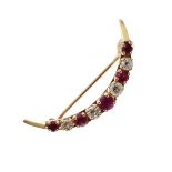 Crescent shaped brooch set alternate diamonds and ruby coloured stones, stamped 14kt Condition: