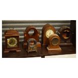 Six assorted early to mid 20th Century mantel clocks to include; a carved walnut bracket clock