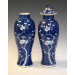 Pair of Chinese blue and white baluster shaped vases and one cover having prunus blossom decoration,