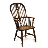 19th Century ash framed stick back Windsor elbow chair raised on turned supports, united by a